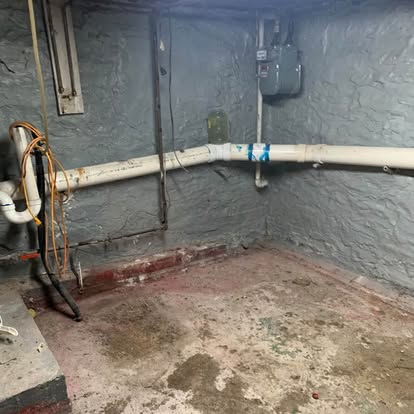Empty basement corner after Haul Hogs removed the old appliances